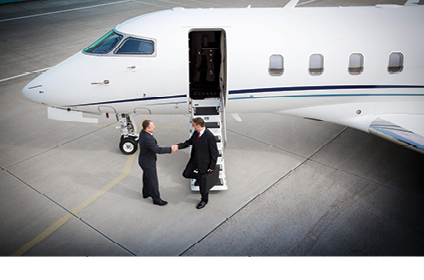 Two business men shaking hands after stepping off private jet