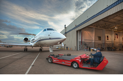 Tug pulling jet into hangar space