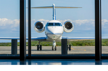 Laptop open on a table inside a private jet